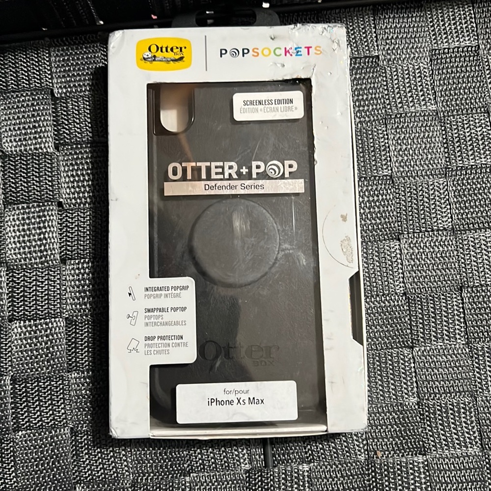 A black otter box and pop socket case